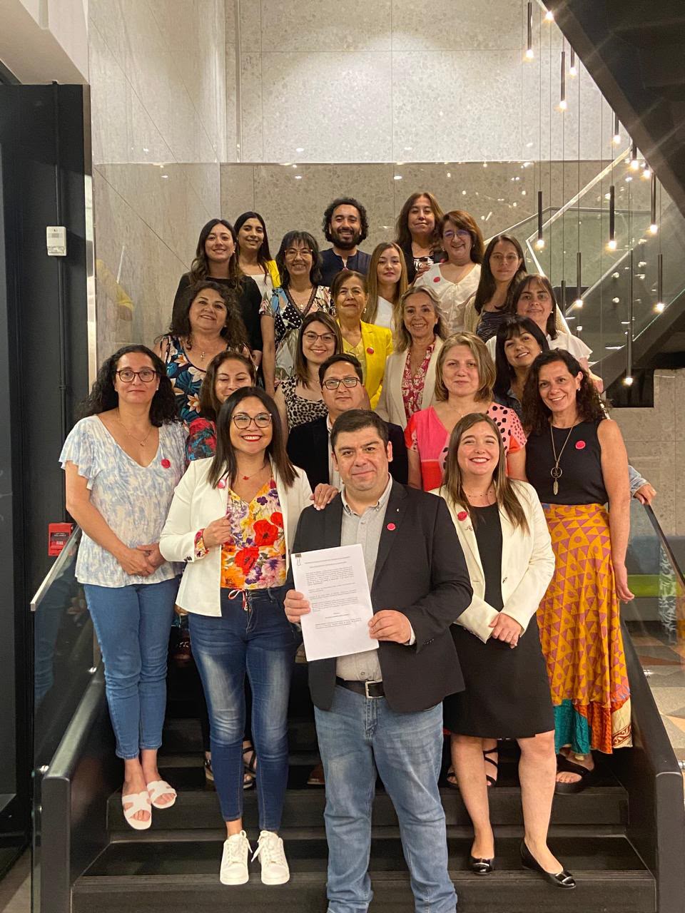 Participantes de la I Jornada SOCHIGEMA 2024 reunidos junto al Acta Fundacional en una escalera.